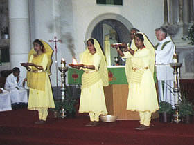 The triple arati done with (L to R) a plate of flowers, fire and incense sticks